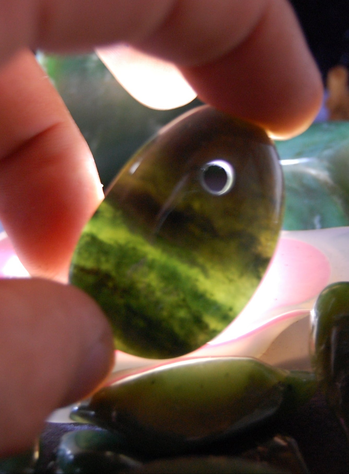 Jade, drilled pebble 43 mm high x 30 wide x 12 thick. Sold with adjustable black cord.