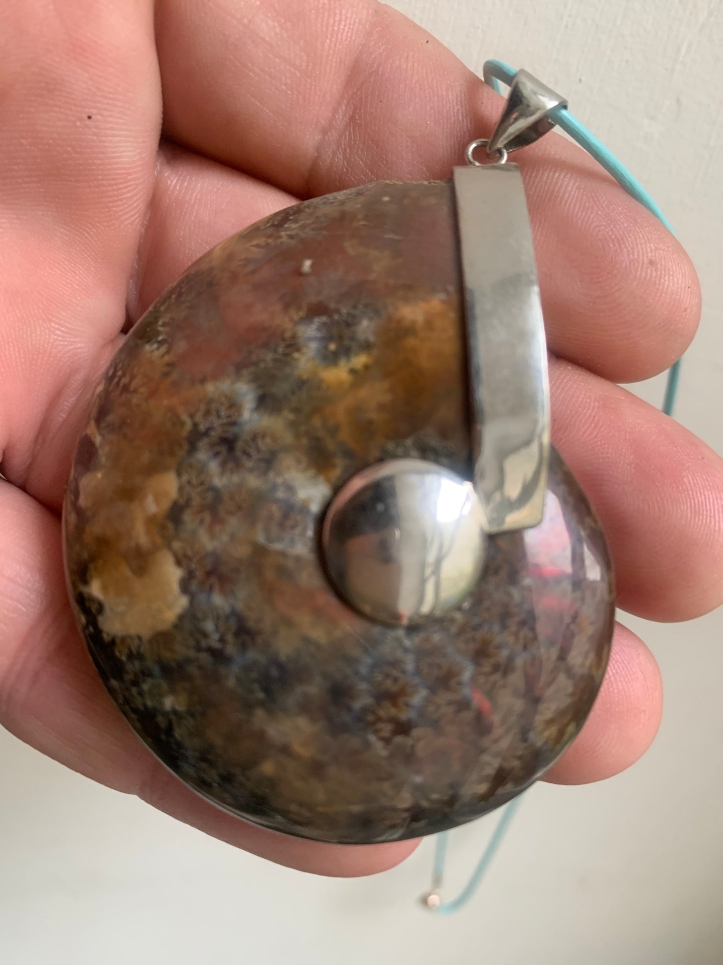 Fossil ammonite pendants, available in two sizes: 60x50x20 and 35x25x10 mm. Each piece is authentic and unique, revealing the natural spirals and fascinating patterns of this fossil. Comes with a drawstring, ready to wear or give as a gift!