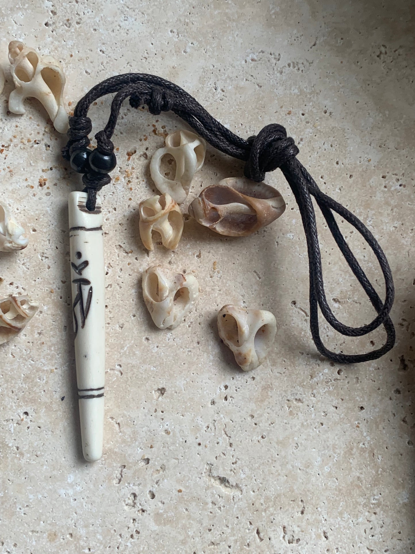 Elegant handcrafted pendant from Nepal, carved from bone with the sacred Om symbol, 60 millimeters high x 10 millimeters in diameter. Sold with a free adjustable black cord, perfect!