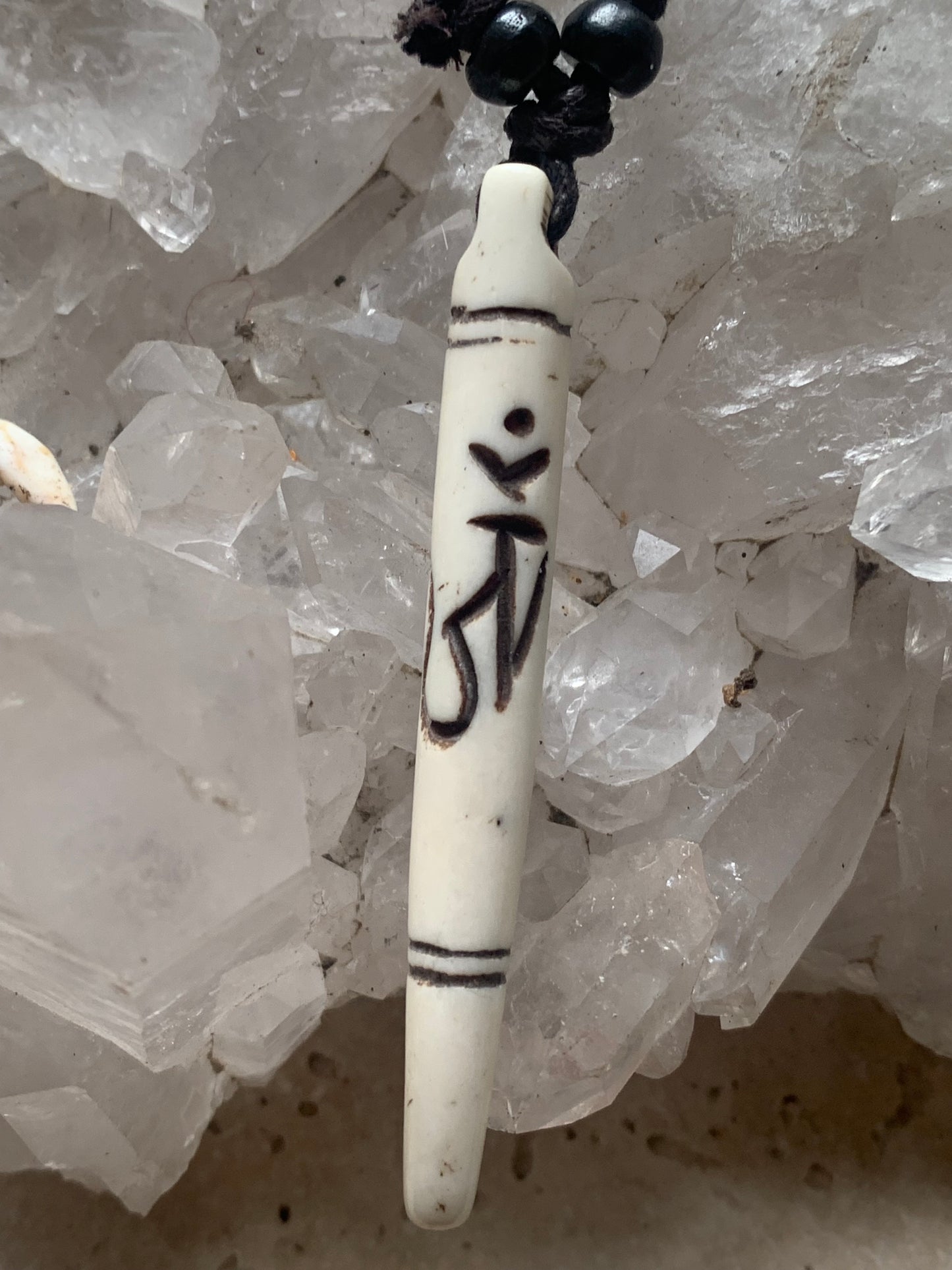 Elegant handcrafted pendant from Nepal, carved from bone with the sacred Om symbol, 60 millimeters high x 10 millimeters in diameter. Sold with a free adjustable black cord, perfect!