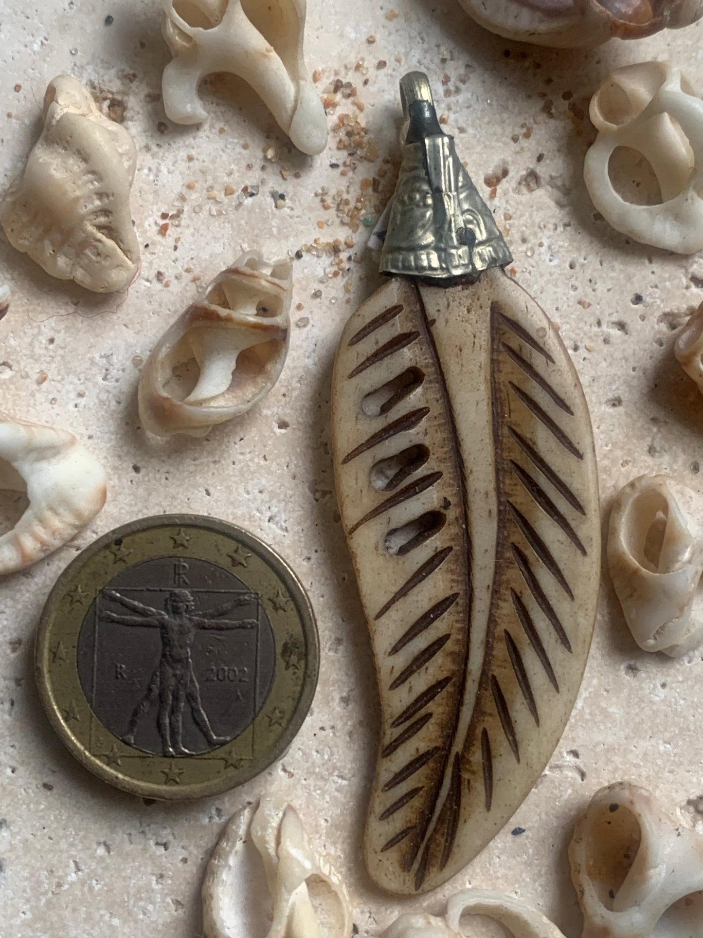 Handcrafted feather-shaped pendant from Nepal, carved from bone, measuring 70 millimeters high x 22 wide x 5 thick. Sold with a free adjustable black cord, perfect!