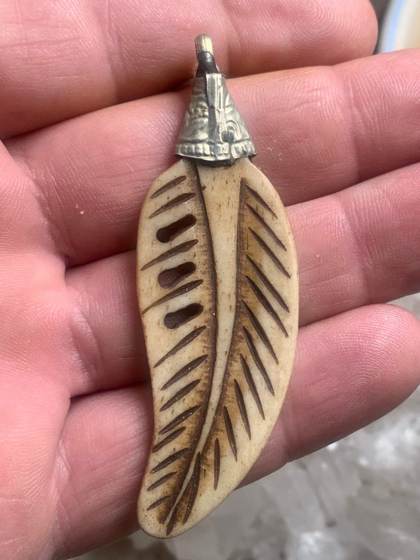 Handcrafted feather-shaped pendant from Nepal, carved from bone, measuring 70 millimeters high x 22 wide x 5 thick. Sold with a free adjustable black cord, perfect!