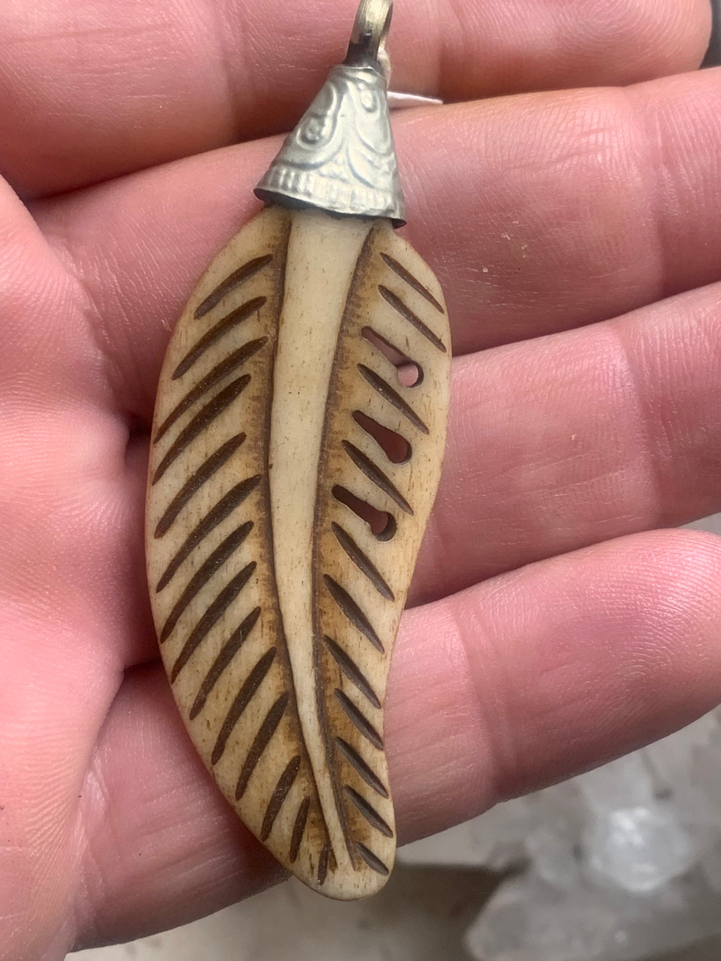 Handcrafted feather-shaped pendant from Nepal, carved from bone, measuring 70 millimeters high x 22 wide x 5 thick. Sold with a free adjustable black cord, perfect!