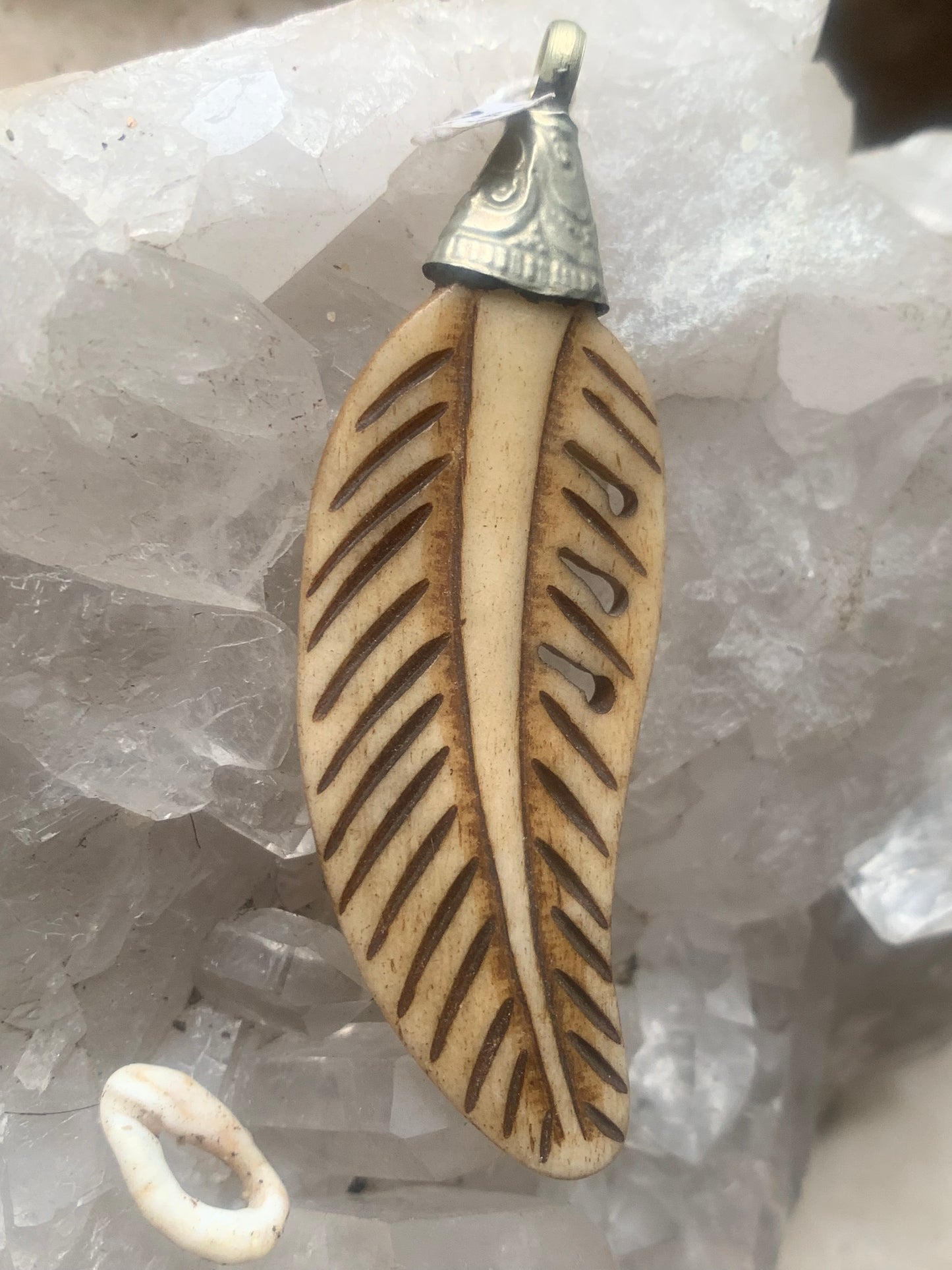 Handcrafted feather-shaped pendant from Nepal, carved from bone, measuring 70 millimeters high x 22 wide x 5 thick. Sold with a free adjustable black cord, perfect!