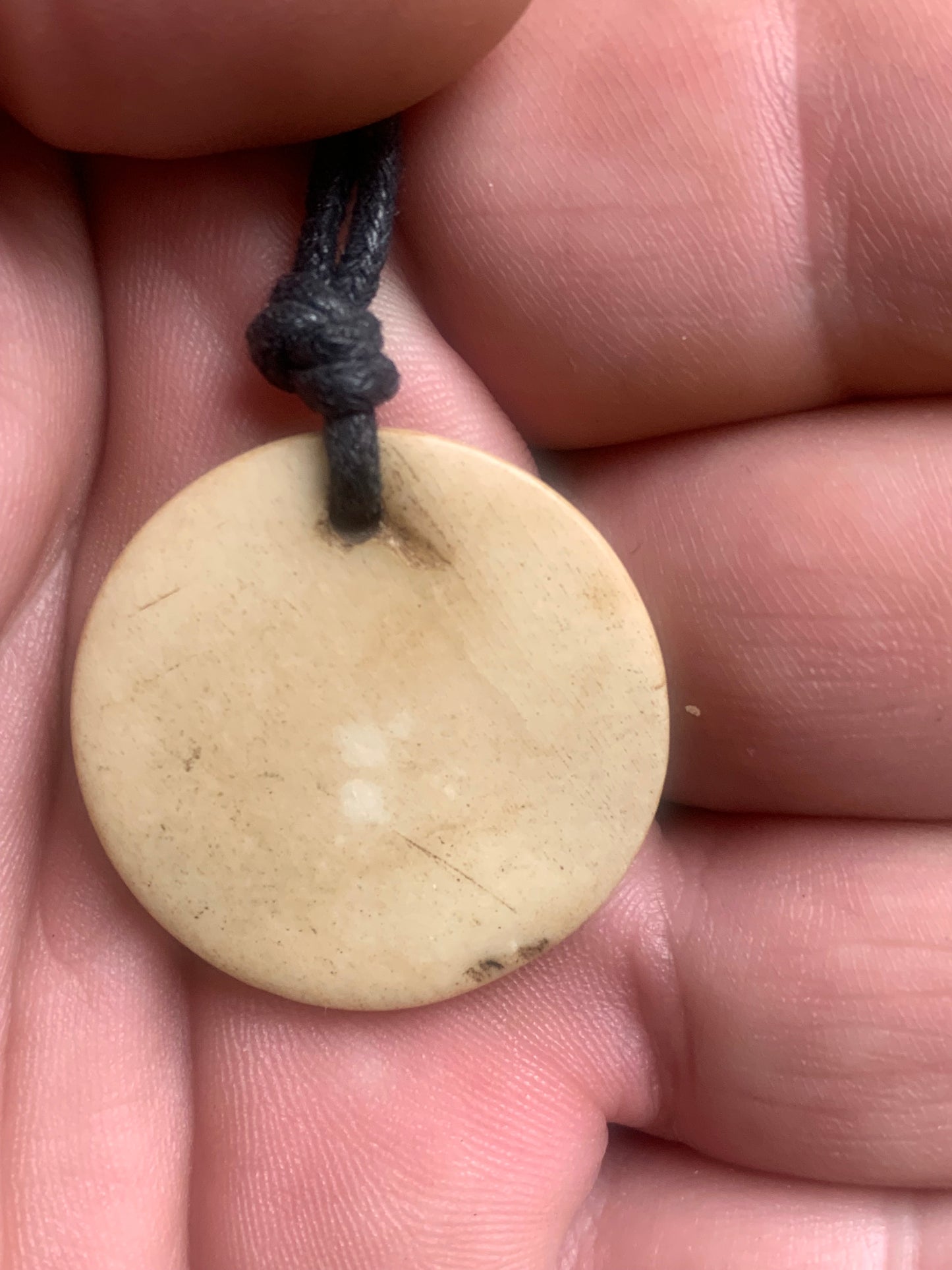 Handcrafted pendant from Nepal with Om symbol, carved from bone, 30 millimeters in diameter x 4 mm thick. Sold with a free adjustable black cord, perfect!