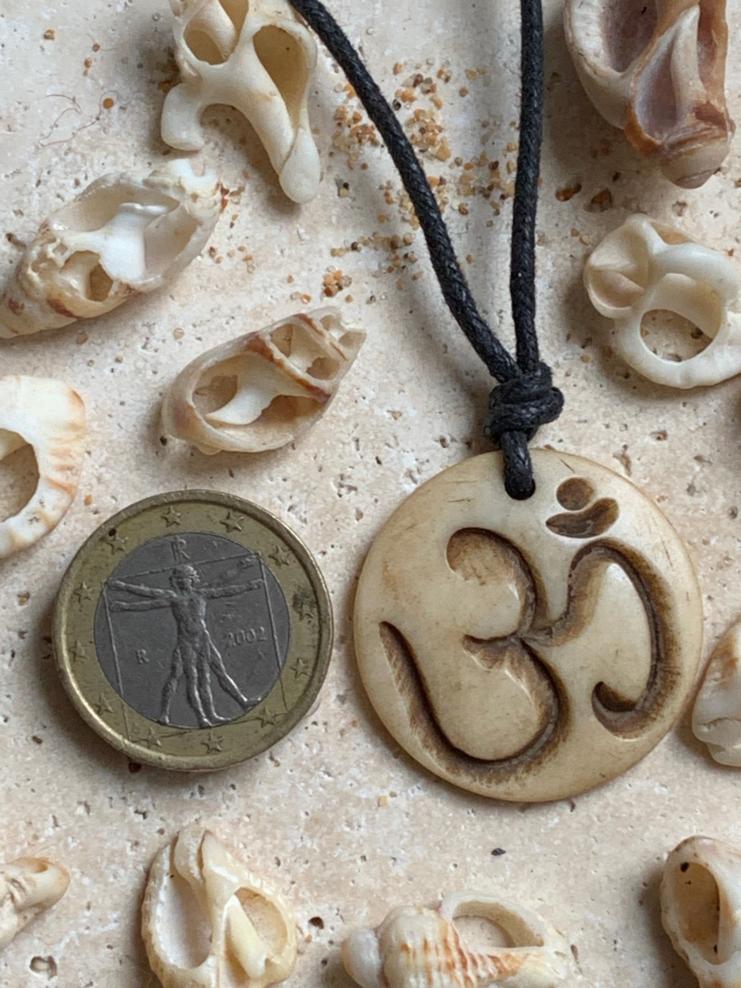 Handcrafted pendant from Nepal with Om symbol, carved from bone, 30 millimeters in diameter x 4 mm thick. Sold with a free adjustable black cord, perfect!