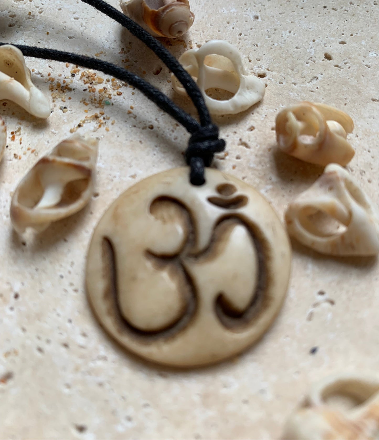 Handcrafted pendant from Nepal with Om symbol, carved from bone, 30 millimeters in diameter x 4 mm thick. Sold with a free adjustable black cord, perfect!