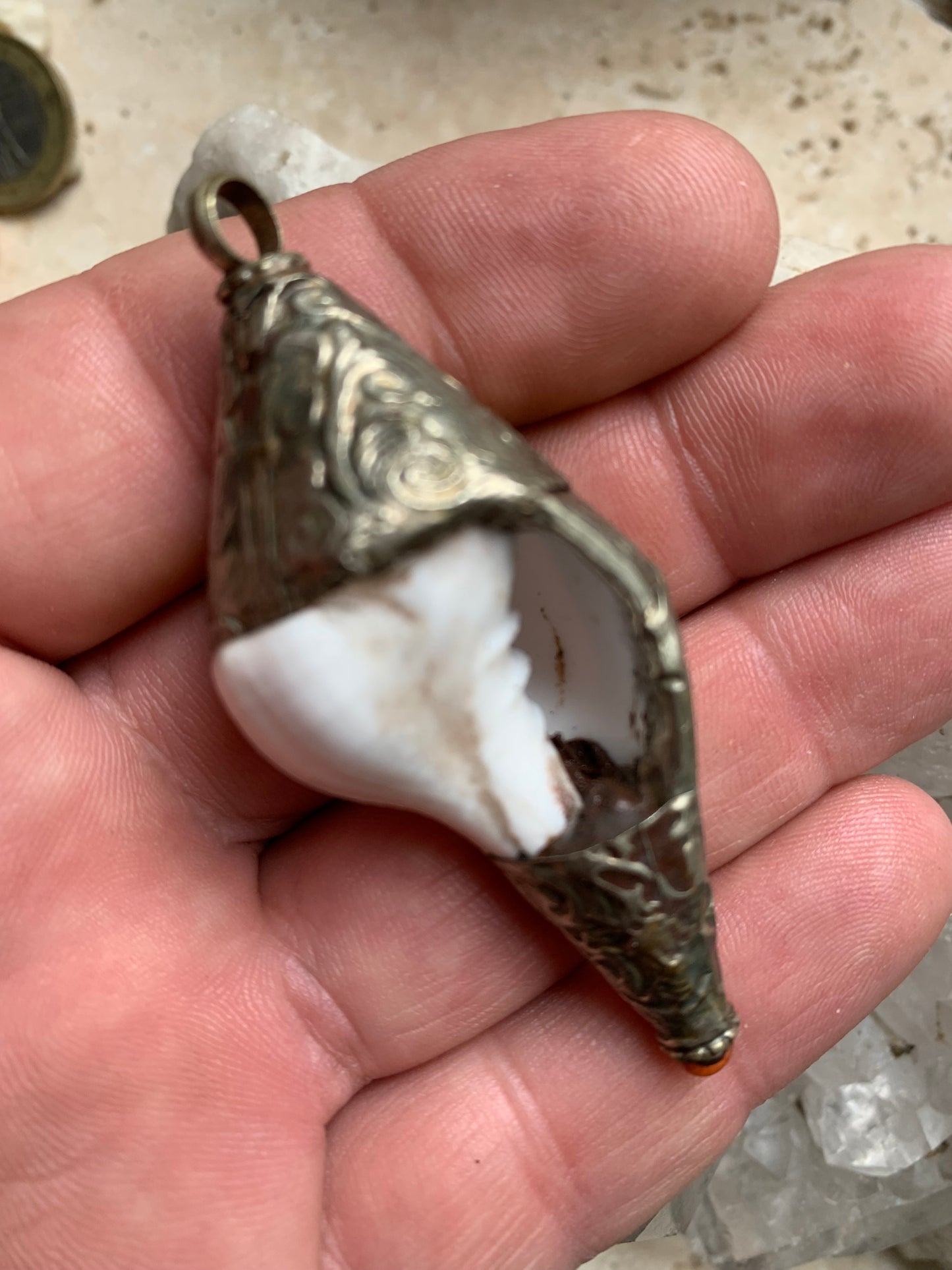 Handcrafted Nepalese shell pendant set in metal with beautiful engravings and a coral bead! 65 millimeters high x 28 mm in diameter. Sold with a free adjustable black cord, perfect!