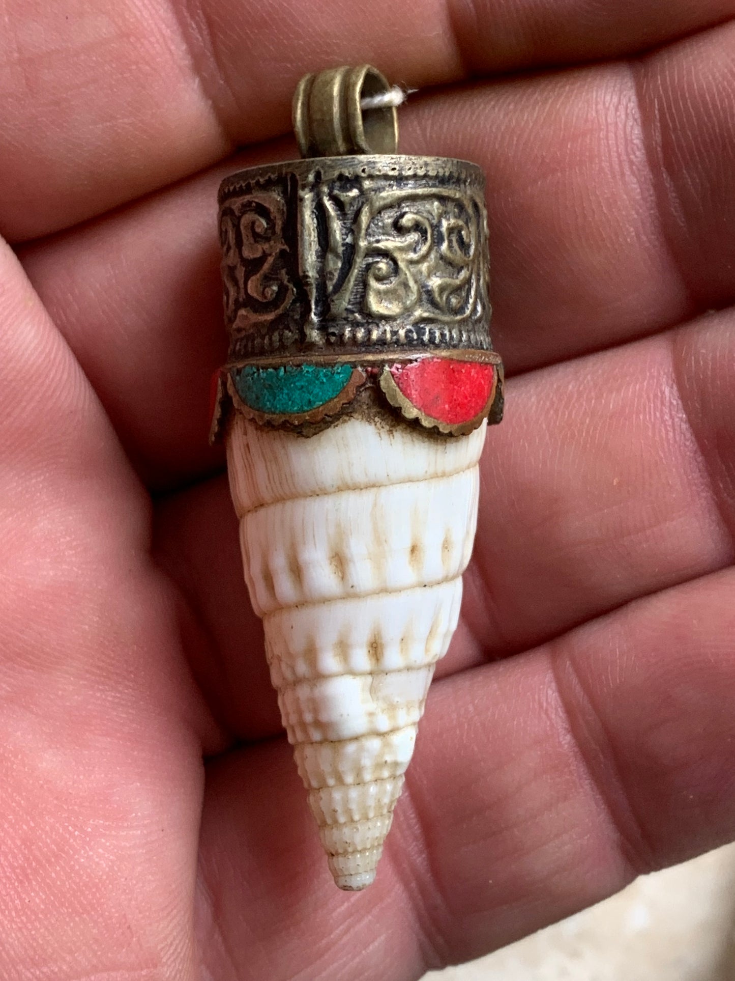 Handcrafted Nepalese shell pendant set in metal with beautiful engravings and turquoise with coral! 53 millimeters high x 18 mm in diameter. Sold with a free adjustable black cord, perfect!