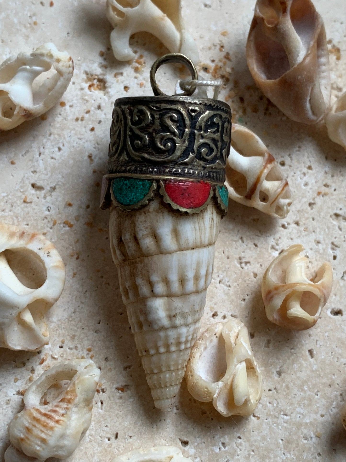 Handcrafted Nepalese shell pendant set in metal with beautiful engravings and turquoise with coral! 53 millimeters high x 18 mm in diameter. Sold with a free adjustable black cord, perfect!