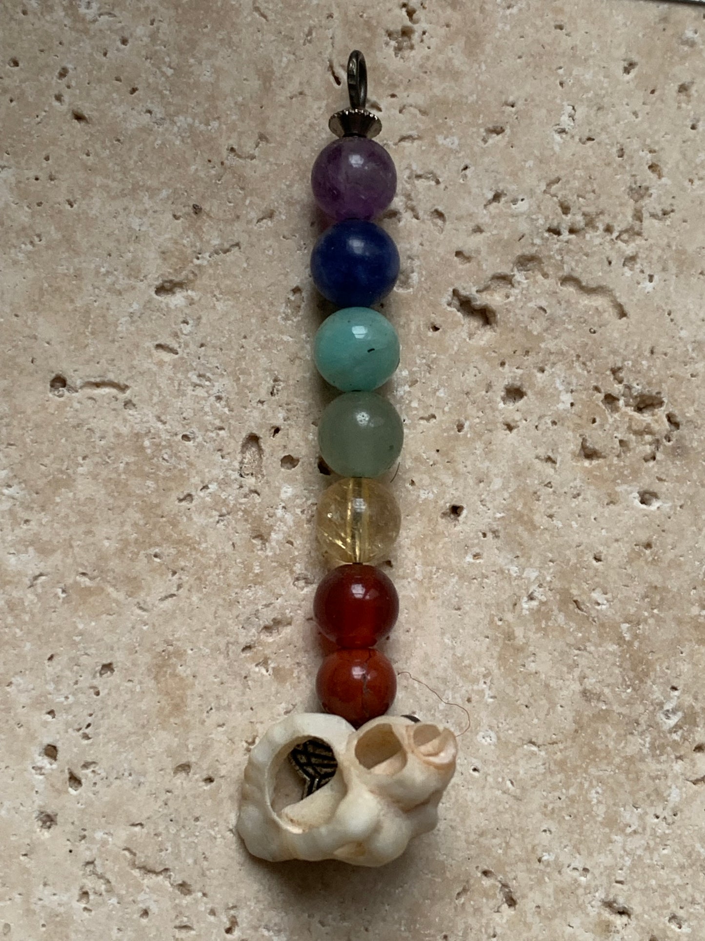 Pendentif '7 chakras' fait par Gem & Zen, au choix : 7 perles avec un coquillage naturel ou sans ! De 52 millimètres de hauteur x 6 millimètres de diamètre. Vendu avec cordon réglable de couleur noire !