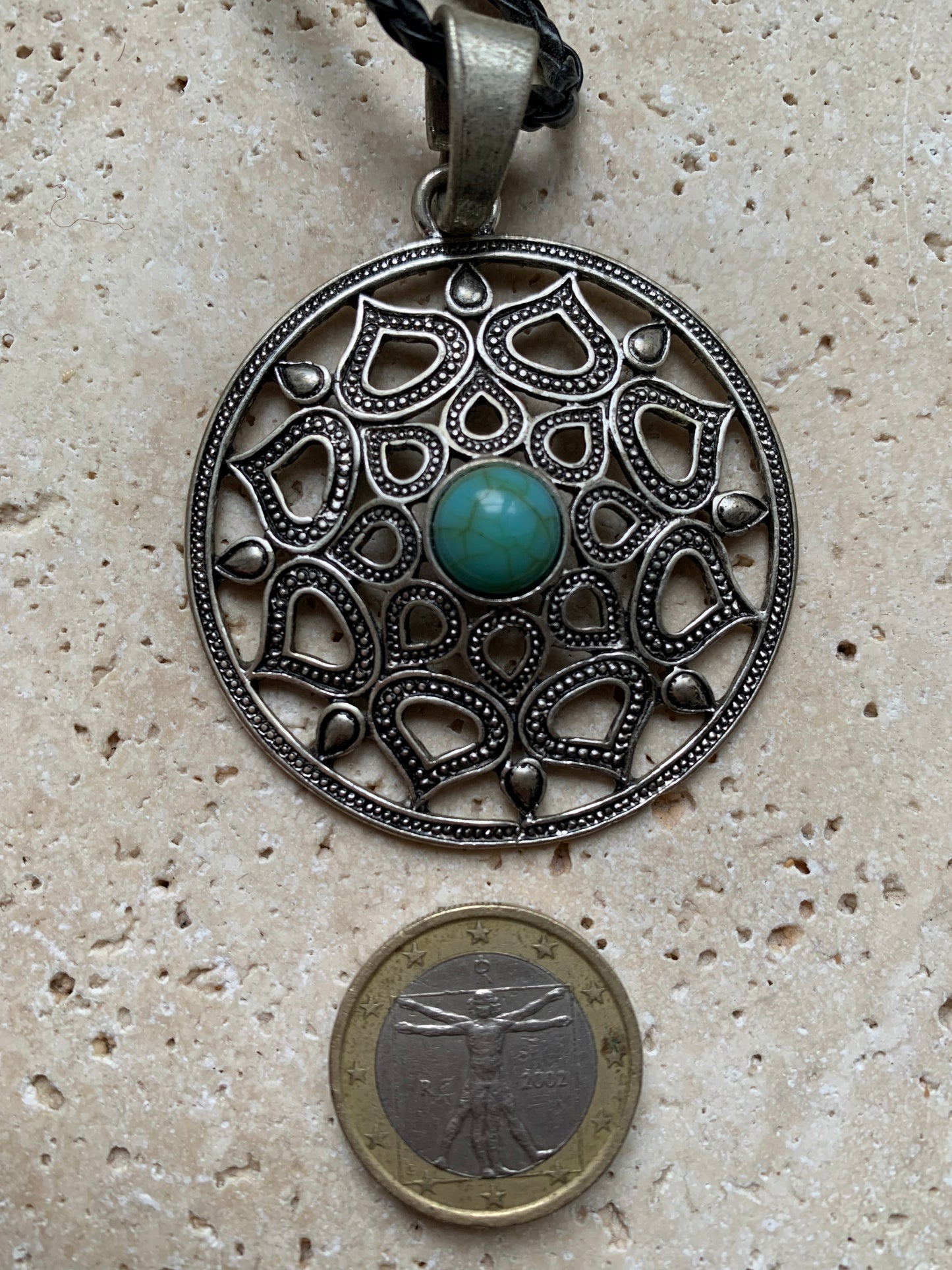 Silver-plated mandala pendant with a blue howlite cabochon in the center. 48 x 12 millimeters. Sold with a free adjustable black cord, perfect!