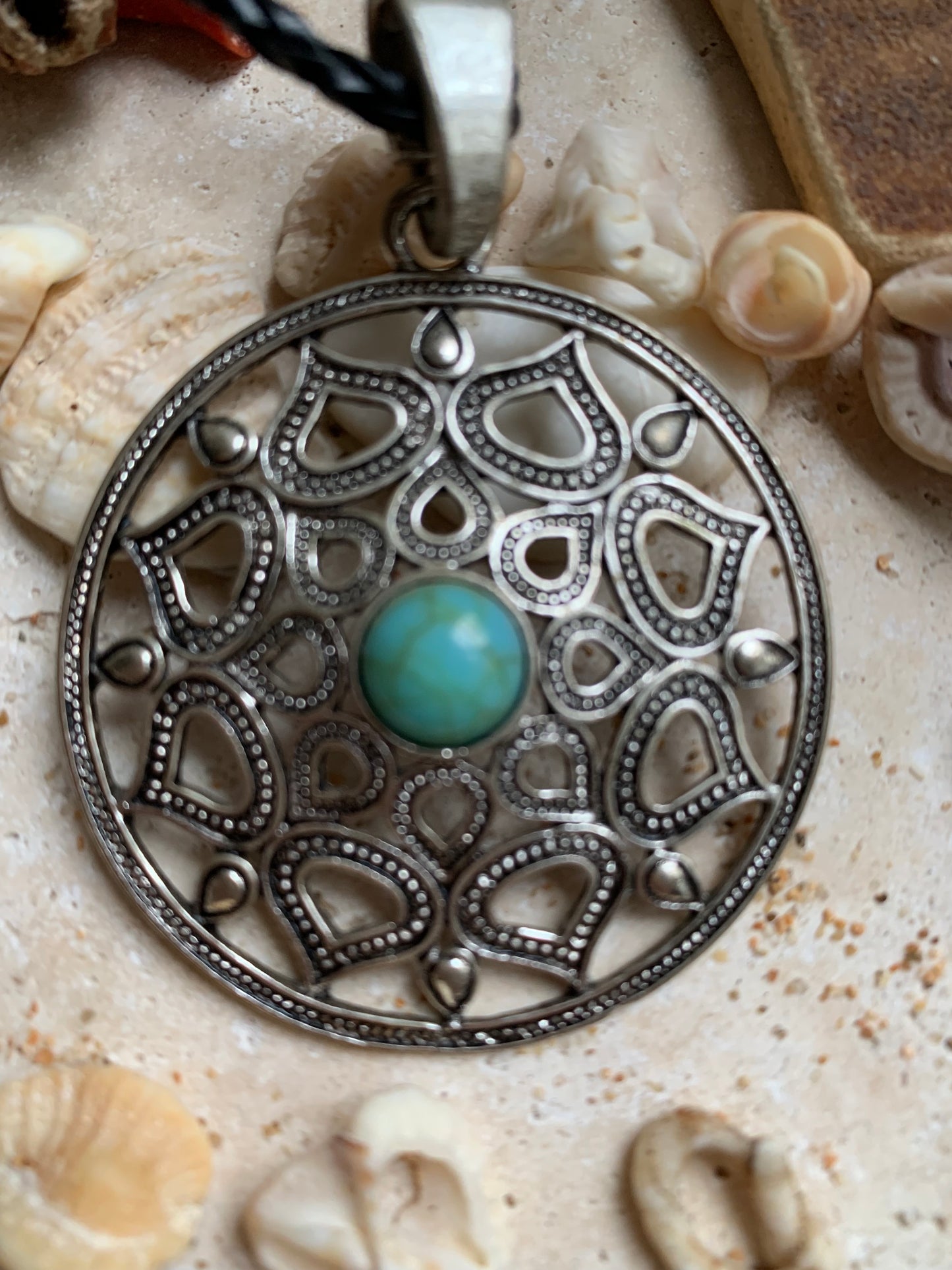 Silver-plated mandala pendant with a blue howlite cabochon in the center. 48 x 12 millimeters. Sold with a free adjustable black cord, perfect!