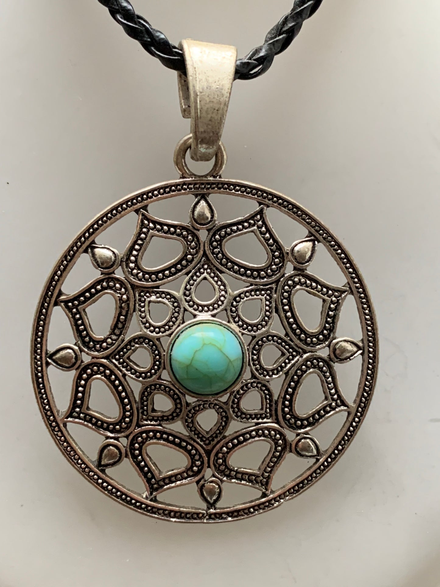 Silver-plated mandala pendant with a blue howlite cabochon in the center. 48 x 12 millimeters. Sold with a free adjustable black cord, perfect!