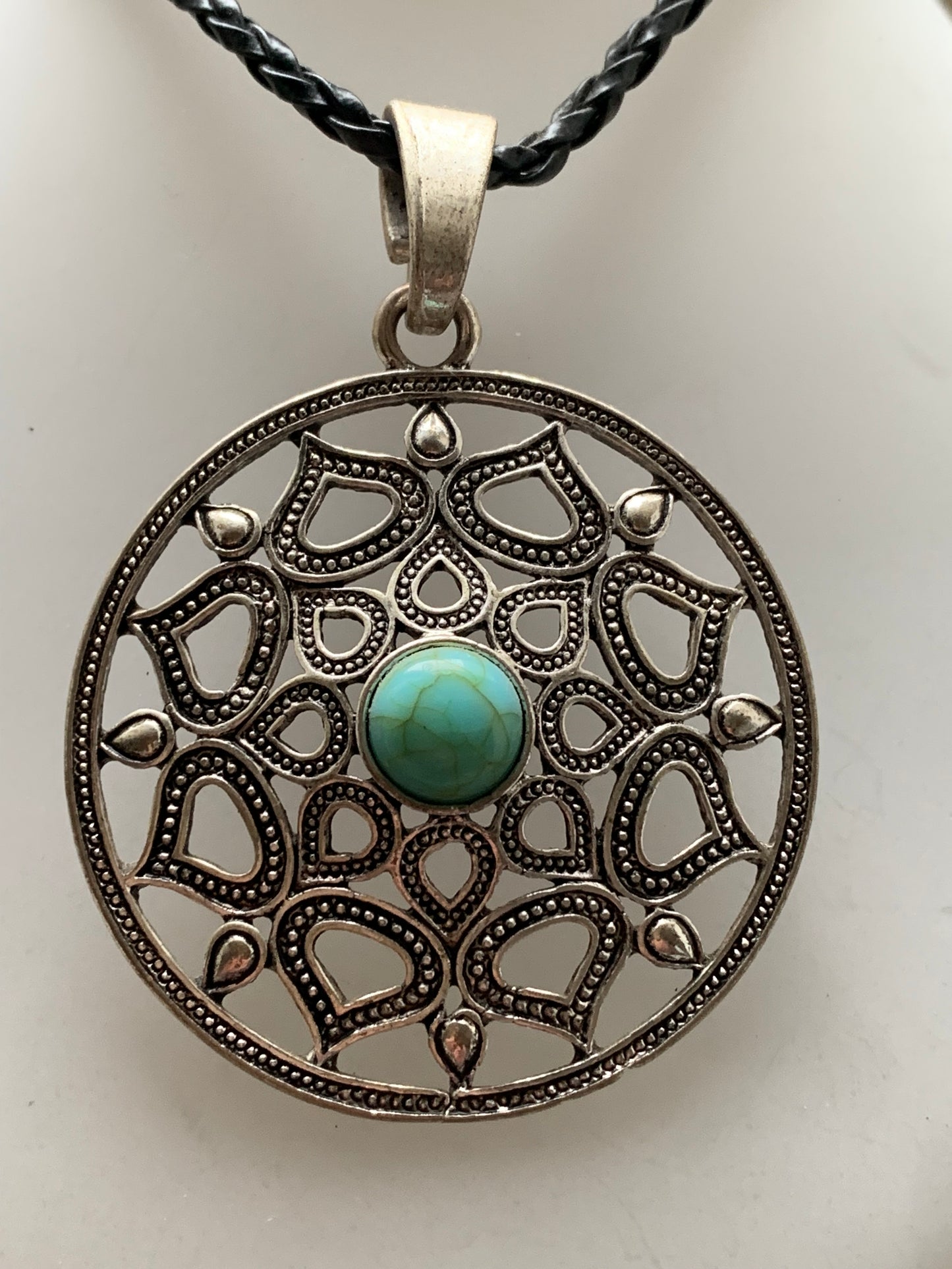 Silver-plated mandala pendant with a blue howlite cabochon in the center. 48 x 12 millimeters. Sold with a free adjustable black cord, perfect!