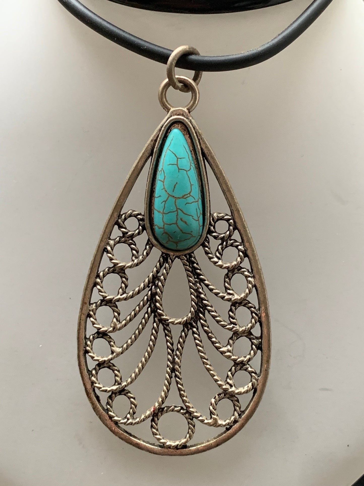 Silver-plated metal pendant in the shape of a mandala with a blue howlite cabochon in the center. 80 millimeters high x 40 wide x 10 thick. Sold with a free adjustable black cord, perfect!