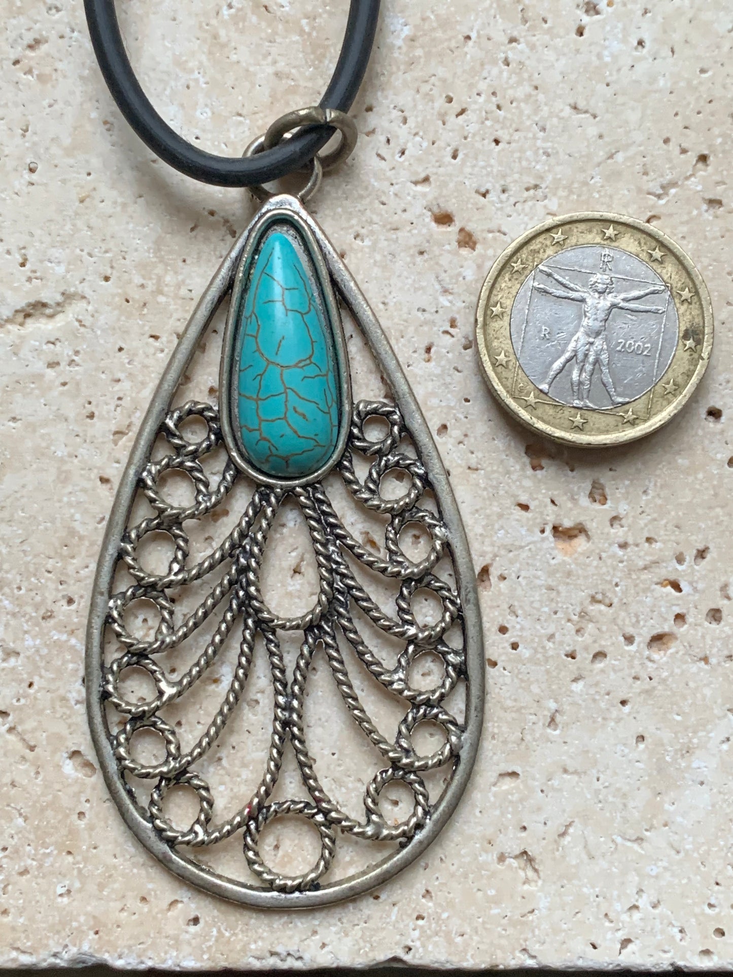 Silver-plated metal pendant in the shape of a mandala with a blue howlite cabochon in the center. 80 millimeters high x 40 wide x 10 thick. Sold with a free adjustable black cord, perfect!