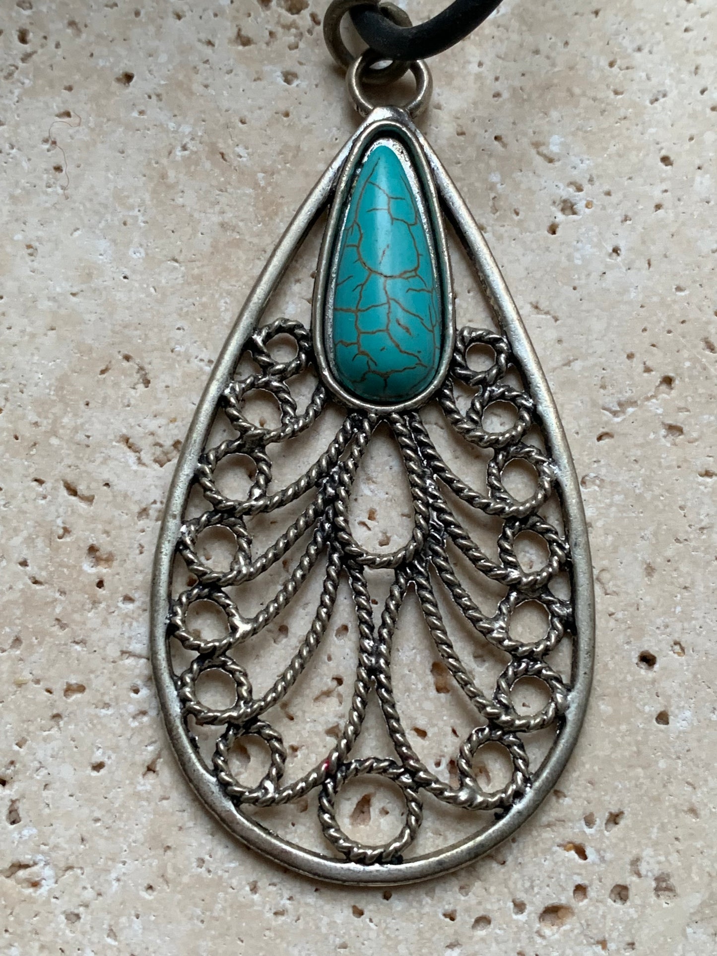 Silver-plated metal pendant in the shape of a mandala with a blue howlite cabochon in the center. 80 millimeters high x 40 wide x 10 thick. Sold with a free adjustable black cord, perfect!
