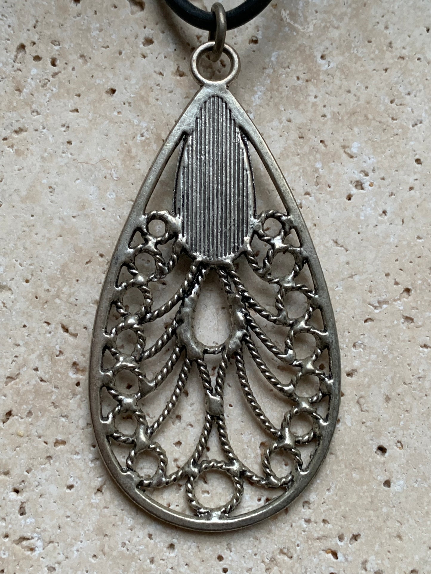 Silver-plated metal pendant in the shape of a mandala with a blue howlite cabochon in the center. 80 millimeters high x 40 wide x 10 thick. Sold with a free adjustable black cord, perfect!
