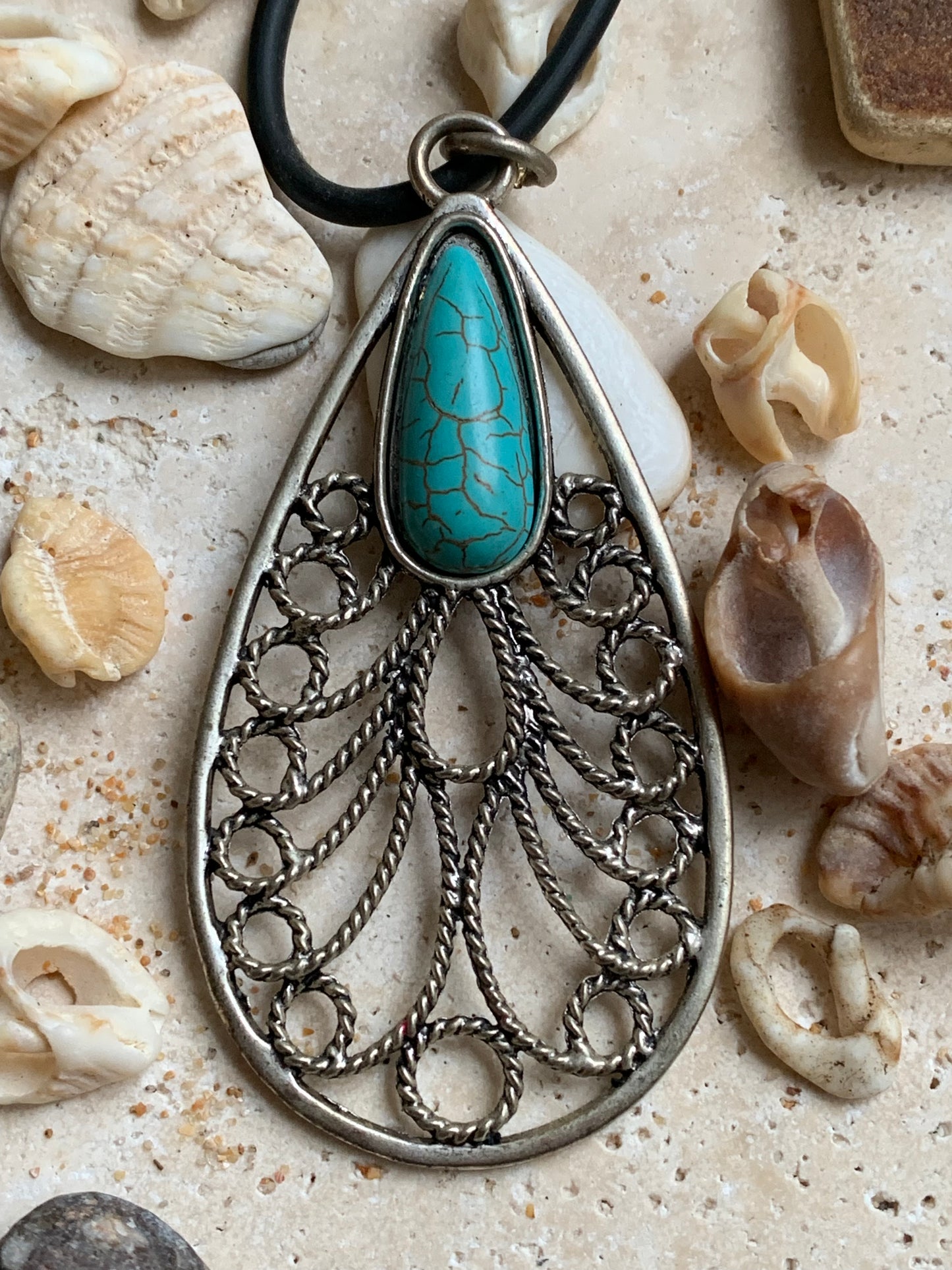 Silver-plated metal pendant in the shape of a mandala with a blue howlite cabochon in the center. 80 millimeters high x 40 wide x 10 thick. Sold with a free adjustable black cord, perfect!