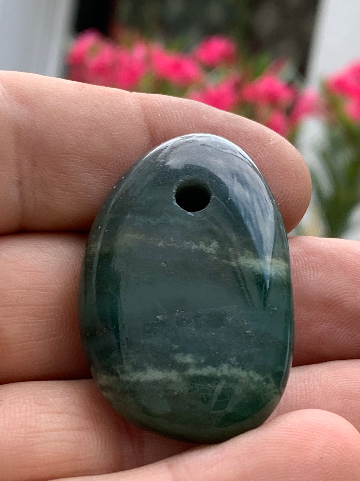 Jade, drilled pebble 43 mm high x 30 wide x 12 thick. Sold with adjustable black cord.