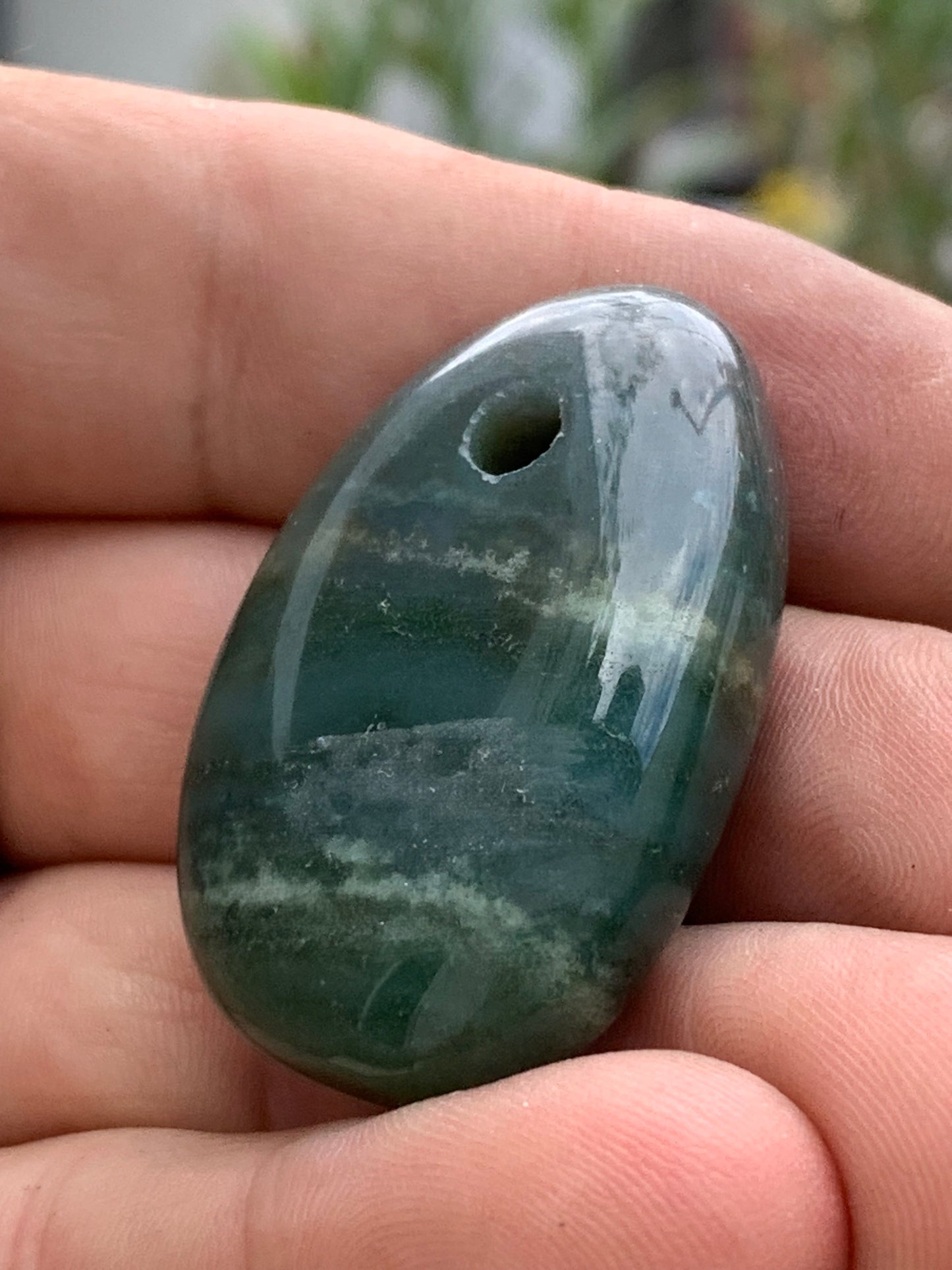 Jade, drilled pebble 43 mm high x 30 wide x 12 thick. Sold with adjustable black cord.