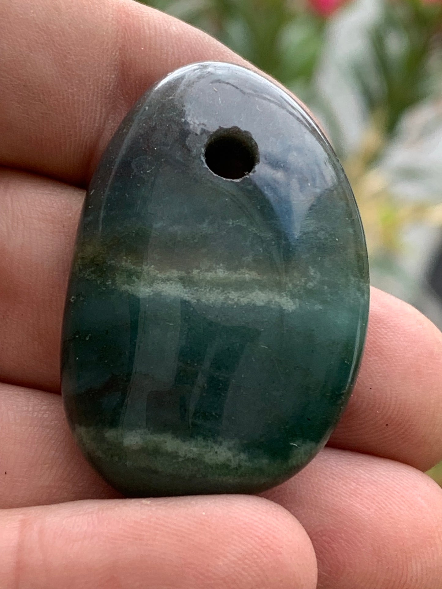 Jade, drilled pebble 43 mm high x 30 wide x 12 thick. Sold with adjustable black cord.