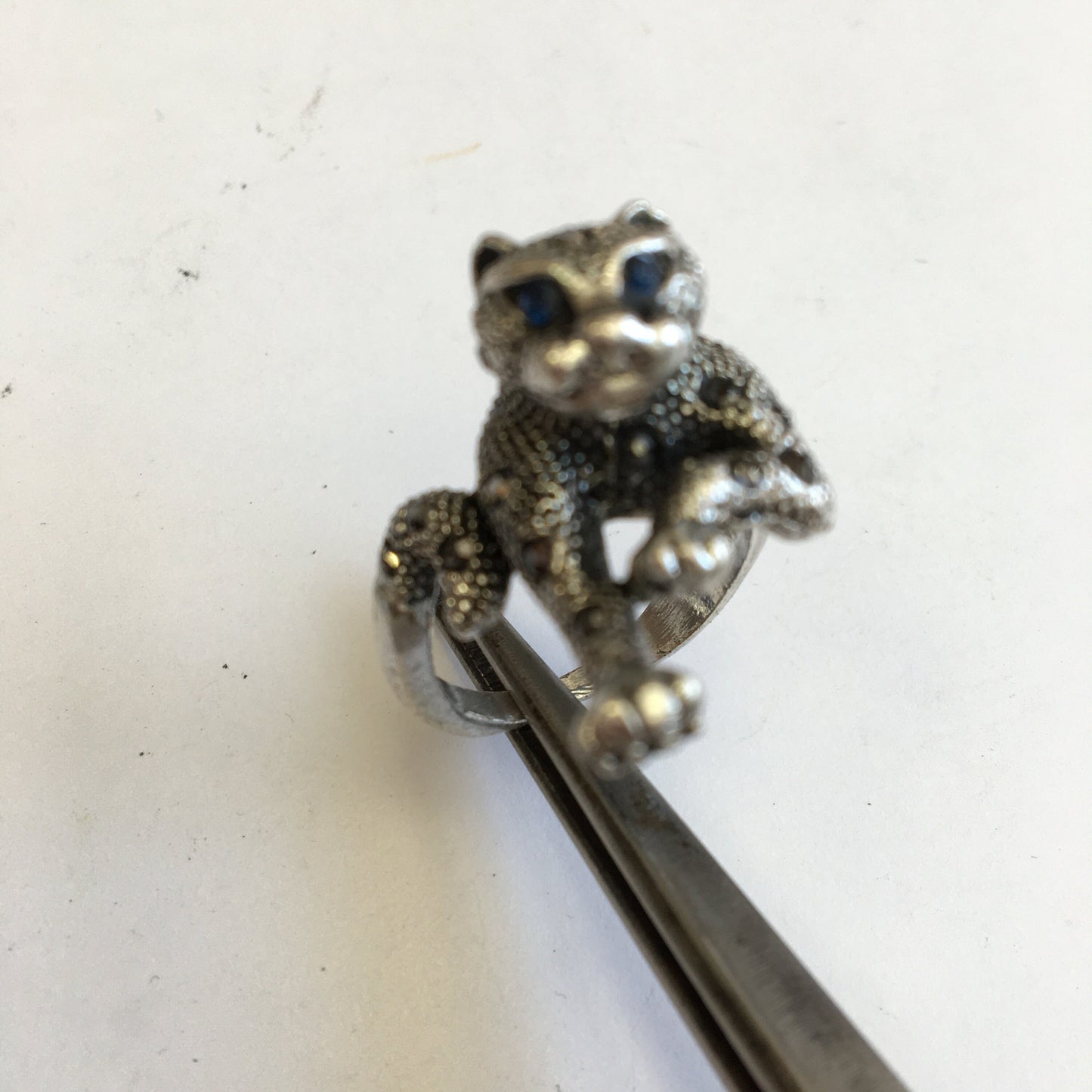 Bague 'panthére', avec incrustation de 2 Saphirs (yeux) et 24 petites pierres facettées, Argent 0.925, taille 55 Fr. Belle réalisation, bague de seconde main !
