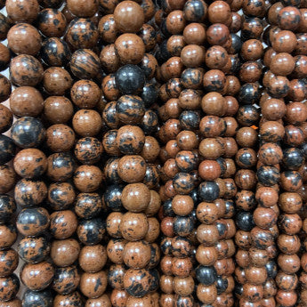 Obsidienne Acajou, perles rondes de 6 ou 8 mm. Vendu en fil de perle 38/39 cm, en bracelet de 17 à 21cm, en collier de 45 ou sautoir de 60cm. Qualité AA à AAA, superbes perles !