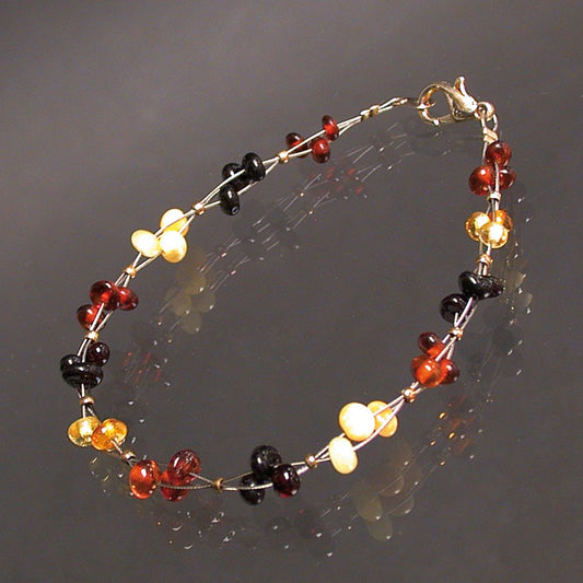 Ambre, bracelet de perles 6 mm à 3 fils torsadés (18 cm) avec fermoir type homard. Une très belle réalisation !