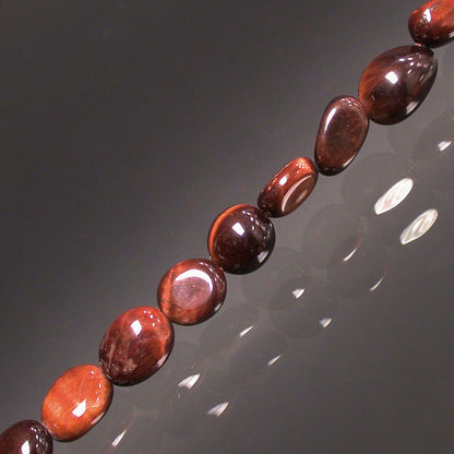 Oeil de taureau, bracelet de 17 à 21cm, collier de 42cm et sautoir de 60cm. Perles de type 'Graine' de formes naturelles montées sur fil de haute résistance !