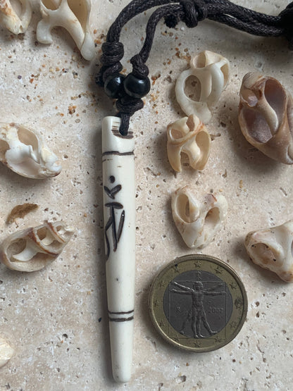 Elegant handcrafted pendant from Nepal, carved from bone with the sacred Om symbol, 60 millimeters high x 10 millimeters in diameter. Sold with a free adjustable black cord, perfect!