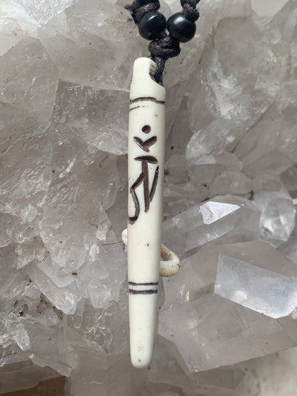 Elegant handcrafted pendant from Nepal, carved from bone with the sacred Om symbol, 60 millimeters high x 10 millimeters in diameter. Sold with a free adjustable black cord, perfect!