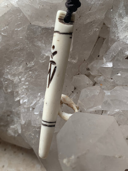 Elegant handcrafted pendant from Nepal, carved from bone with the sacred Om symbol, 60 millimeters high x 10 millimeters in diameter. Sold with a free adjustable black cord, perfect!