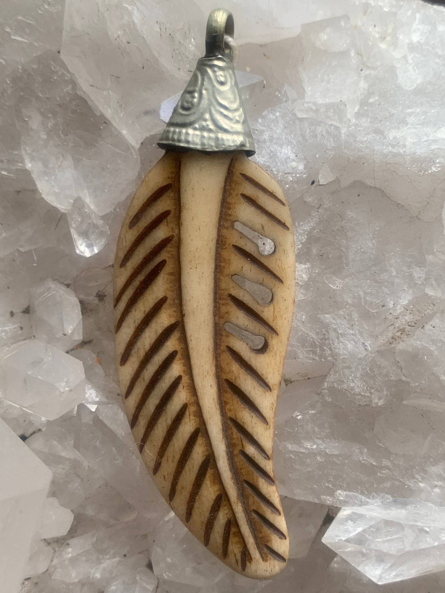 Handcrafted feather-shaped pendant from Nepal, carved from bone, measuring 70 millimeters high x 22 wide x 5 thick. Sold with a free adjustable black cord, perfect!