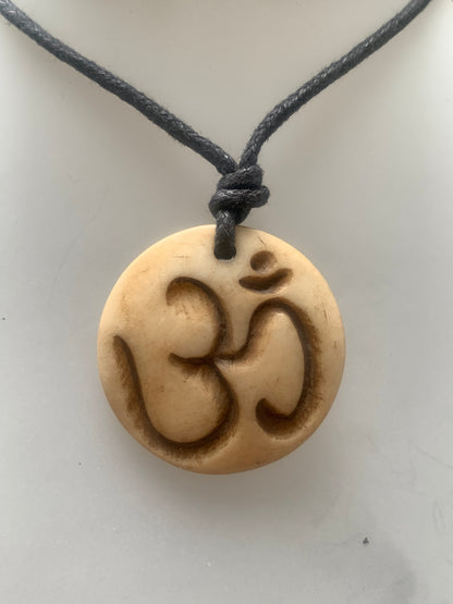 Handcrafted pendant from Nepal with Om symbol, carved from bone, 30 millimeters in diameter x 4 mm thick. Sold with a free adjustable black cord, perfect!