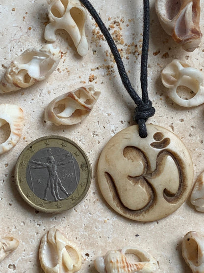 Handcrafted pendant from Nepal with Om symbol, carved from bone, 30 millimeters in diameter x 4 mm thick. Sold with a free adjustable black cord, perfect!