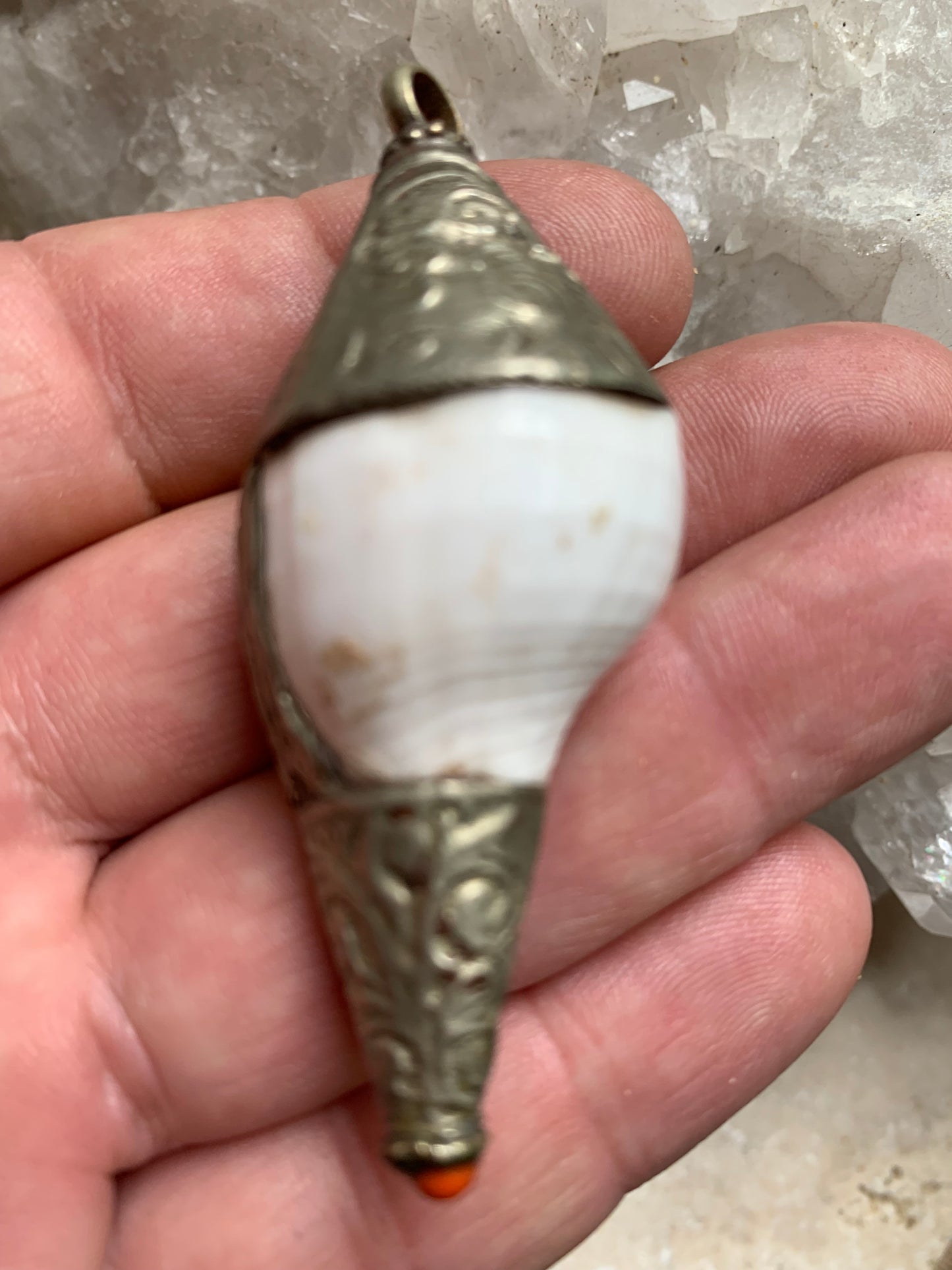 Handcrafted Nepalese shell pendant set in metal with beautiful engravings and a coral bead! 65 millimeters high x 28 mm in diameter. Sold with a free adjustable black cord, perfect!