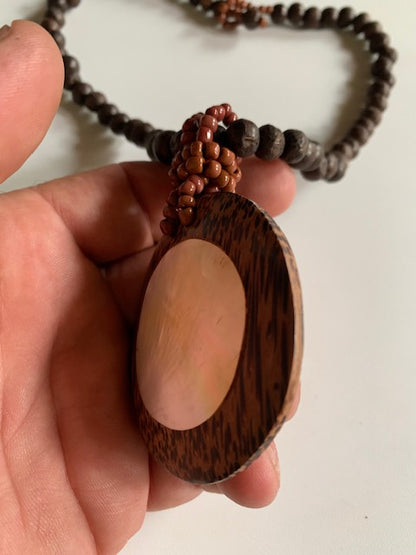 Collier/ Sautoir en perles avec pendentif en bois et nacre - ± 50 centimètres - Pendentif : ± 6 cm