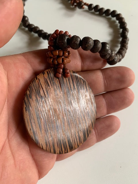 Collier/ Sautoir en perles avec pendentif en bois et nacre - ± 50 centimètres - Pendentif : ± 6 cm
